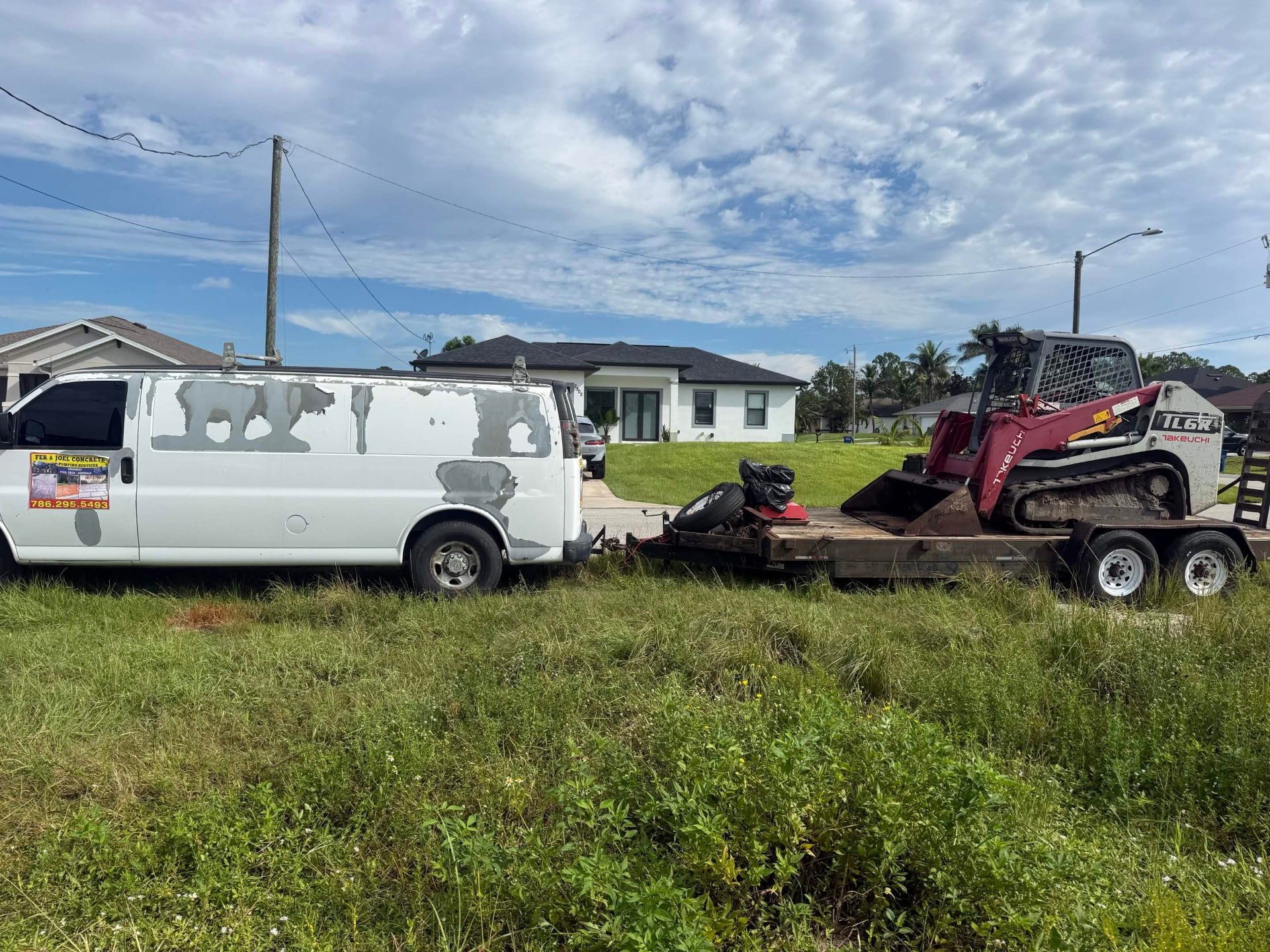 Work van and Takeuchi track loader loaded on the trailer