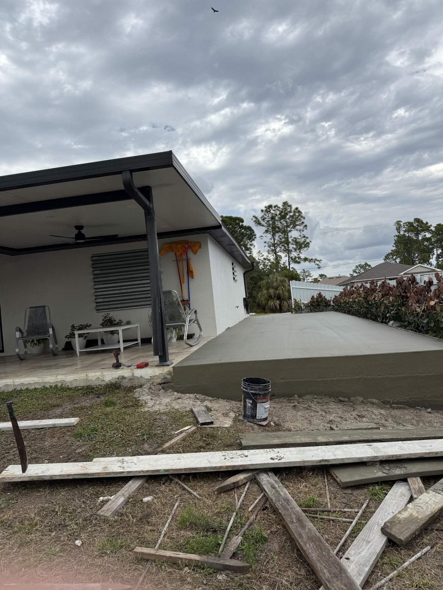 New patio slab poured behind a covered lanai